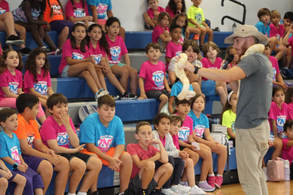 Students watching a Shadow's Reptiles school show in a gymnasium