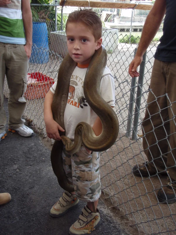 Shadow as a child holding a snake